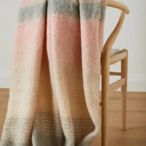 Mohairdecke Heather in Rosé, Grau und Creme auf Sessel oder Sofa drapiert